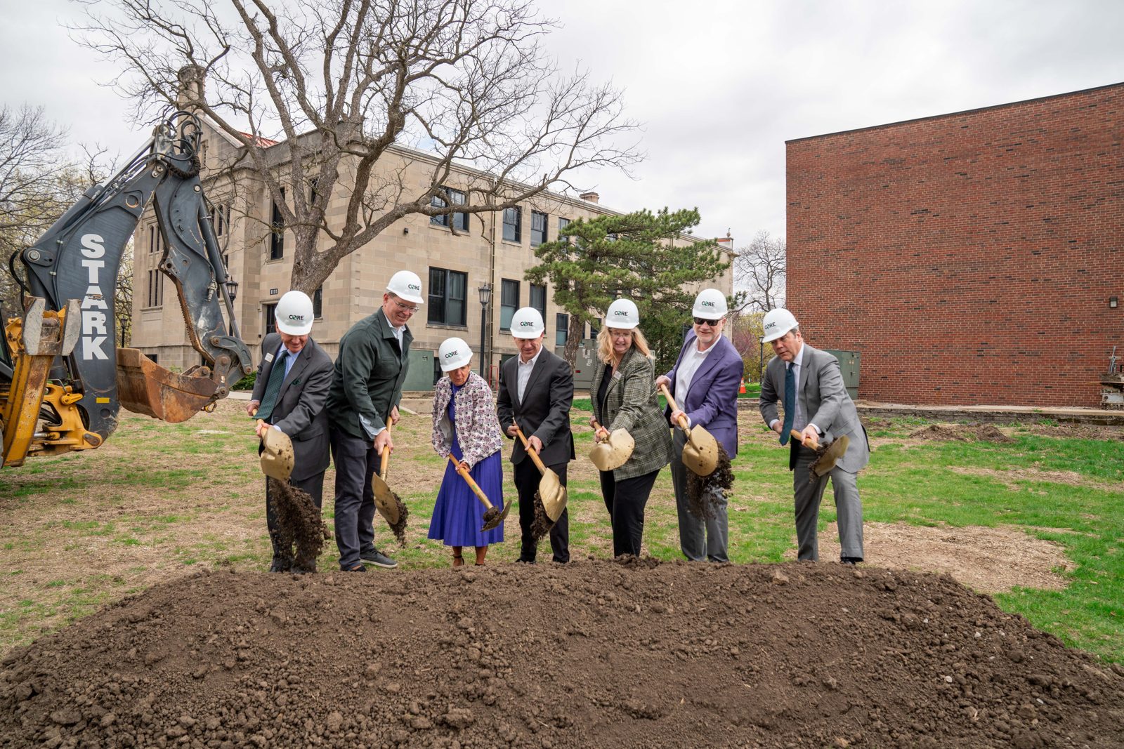 Donors and university leaders turning the first shovels of dirt at a campus groundbreaking